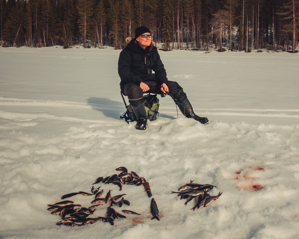 16.4.2020 Man ice fishing with plenty of fish.