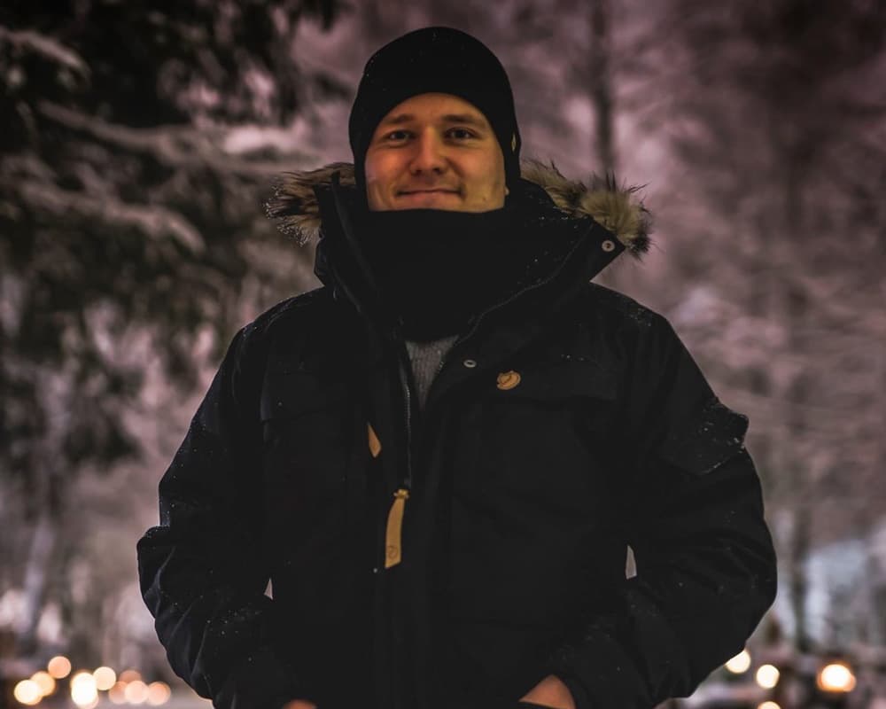 Man standing in graveyard during All Saint's Day.