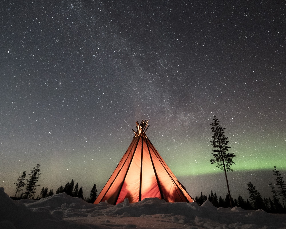 Tepee under the northern lights in Finnish Lapland.