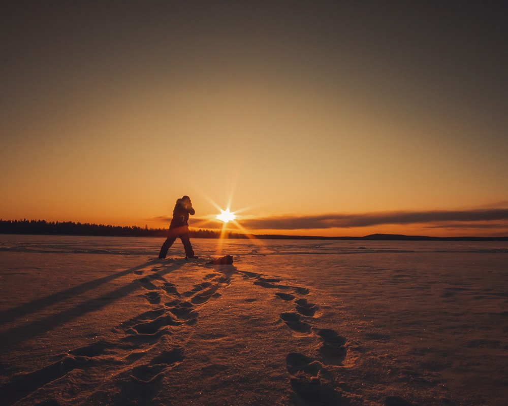 5.4.2020 Man drilling a hole for ice fishing.