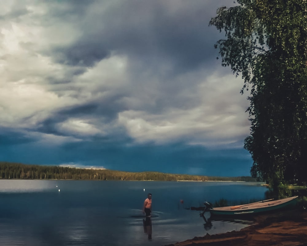 9.7.2020 Man swimming in lake with distant thunder.