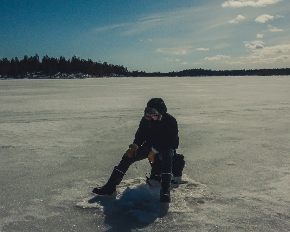 5.5.2020 Man ice fishing in Finnish Lapland.