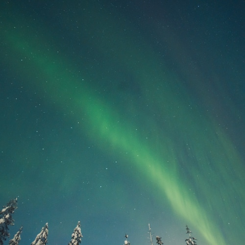 Northern lights arc seen at arctic circle Lapland.