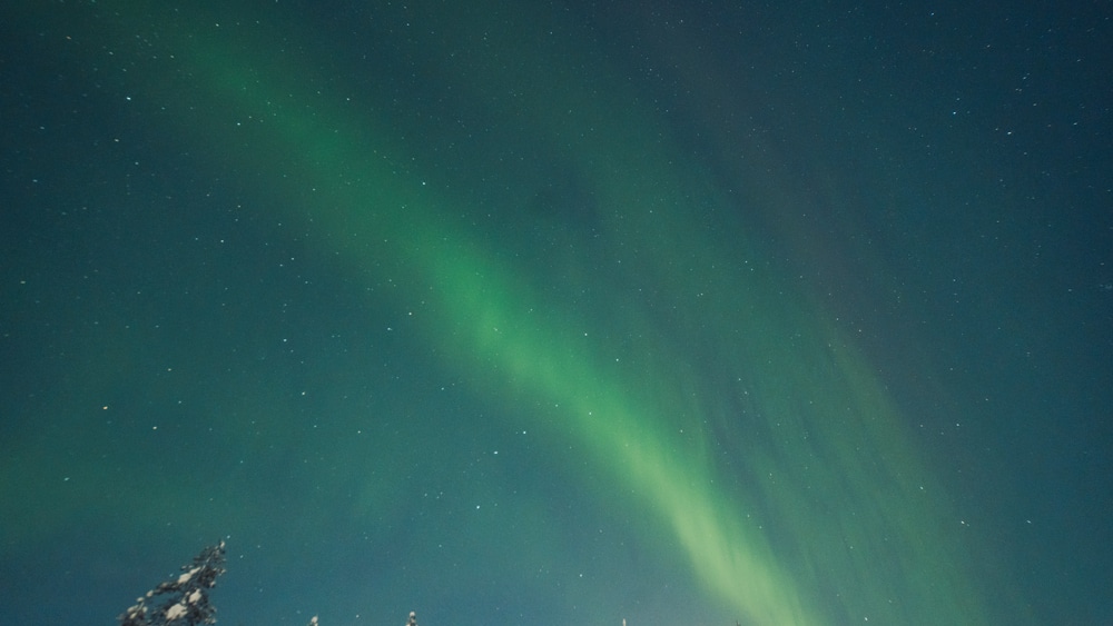 Northern lights arc seen at arctic circle Lapland.