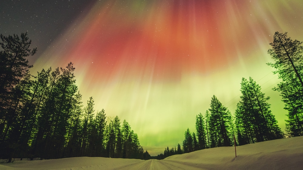 23.3.2023 Red Northern Lights above the road in Rovaniemi, Lapland.