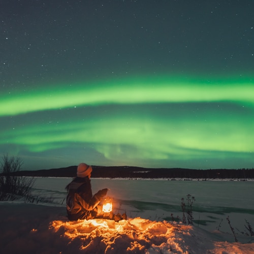 Sitting under the northern lights, Rovaniemi Arctic Circle.