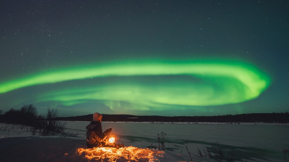 Sitting under the northern lights, Rovaniemi Arctic Circle.